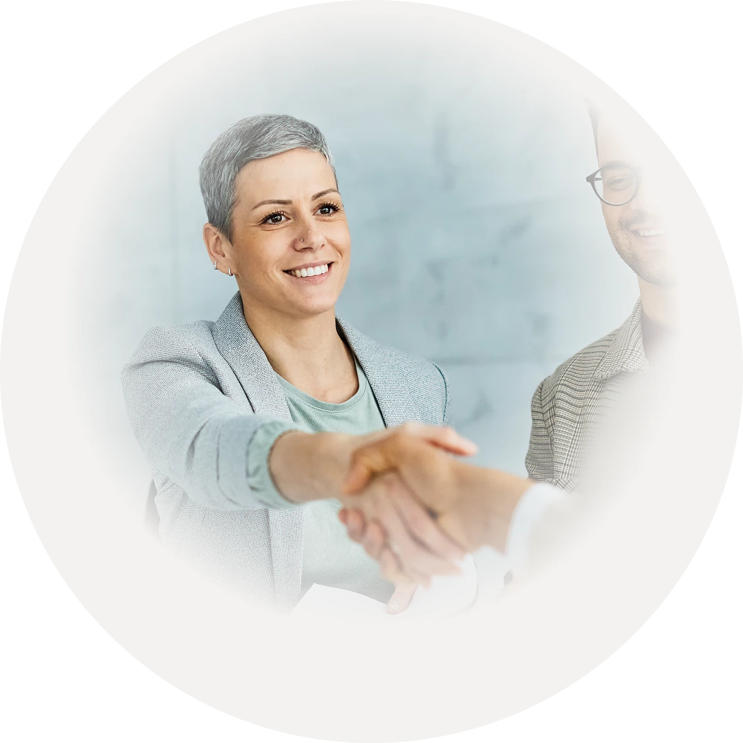 Professionals shaking hands during a business screening and onboarding meeting